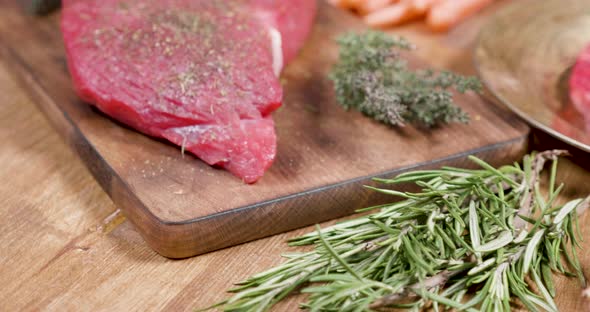 Revealing Shot of a Raw Beef Steak Well Seasoned in a Vintage Composition