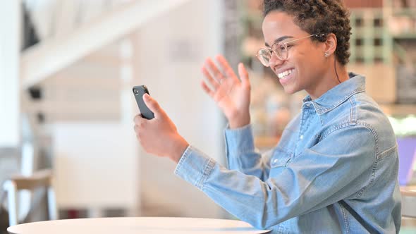 Video Call By African Woman on Smartphone at Cafe 