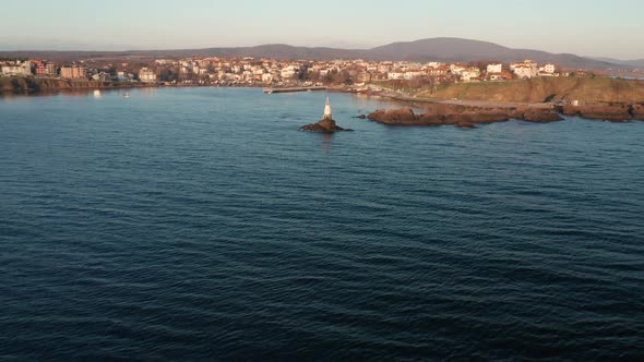 A drone flight at sunrise around the lighthouse in the port of Ahtopol