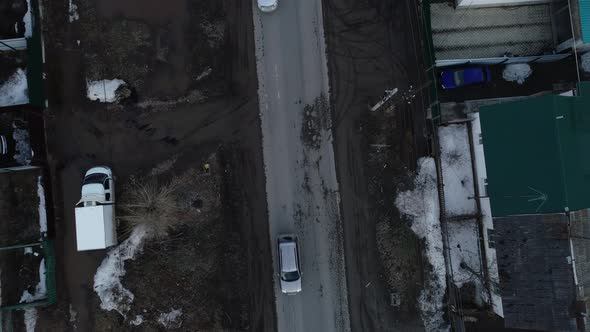 Top down Aerial view of cars drive on the spring road in the village 06