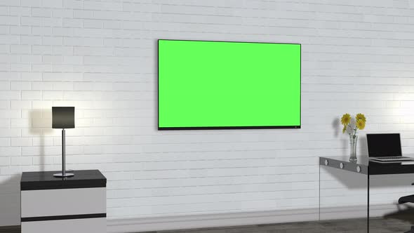 A room inside the building with furniture and a green screen TV on the wall.