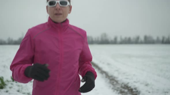 Woman Jogging Behind Camera on Winter Day