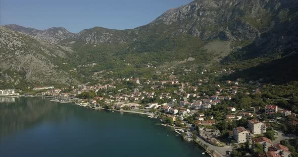 Risan in Montenegro, filmed from the air with mountains behind and the bay of Kotor in front