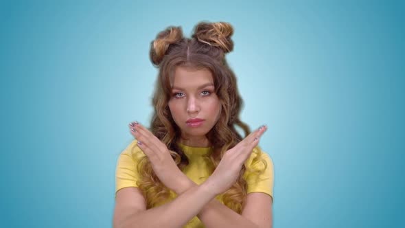 Attractive Young Girl in Yellow Shirt Showing Ban Gesture