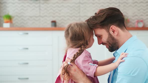 Young father hugging little daughter at home