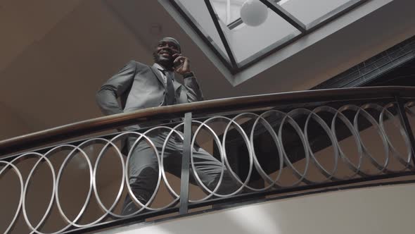 Businessman with Cellphone on Staircase