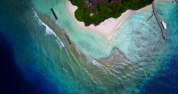Wide angle drone abstract shot of a white paradise beach and aqua blue ocean background in high reso
