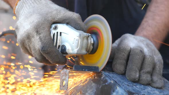Detail View on Metal Processing with Circular Saw and Sparks Flying Around. Mechanic Grinding Metal