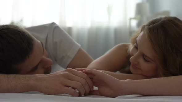 Boyfriend and Girlfriend Holding Hands Lying Bed, Looking With Love, Tenderness