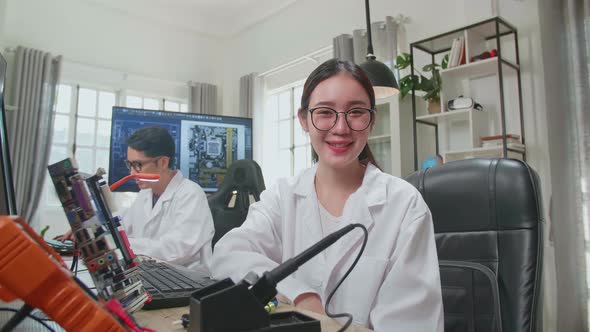 Woman Smiling Charmingly Looking At Camera. Young Intelligent Female Scientist Working In Office