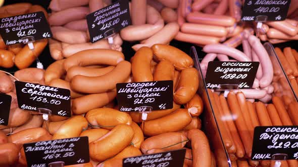 Sausages with Price Tags on the Showcase in the Store. Meats Sale in Butcher Shop