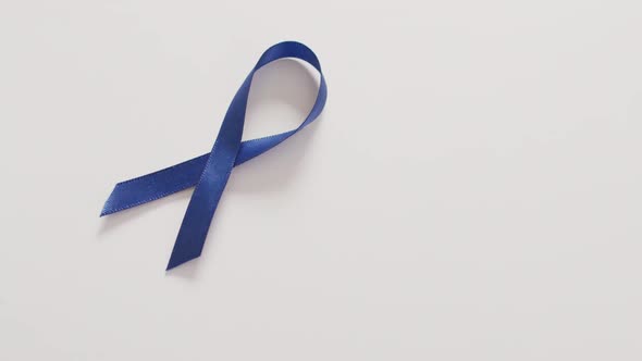Video of dark blue colon cancer ribbon on white background
