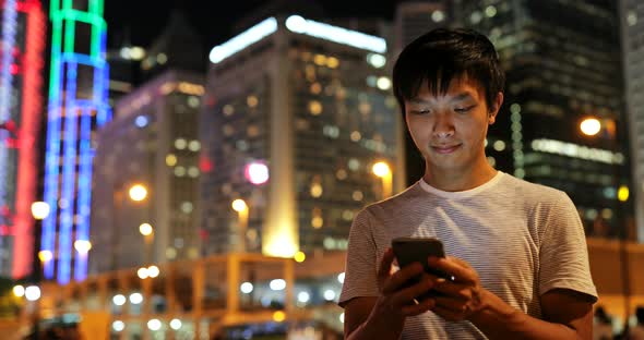 Man using mobile phone in evening 