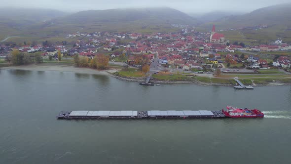 Cargo Pusher Boat on a River Transporting Cargo and Goods