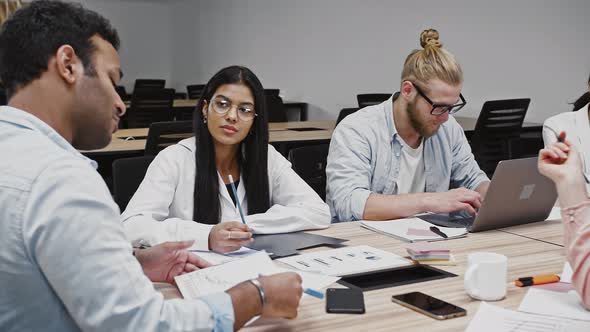 Manager Conveying His Ideas According to New Startup Project to Group of Diverse Colleagues Sitting