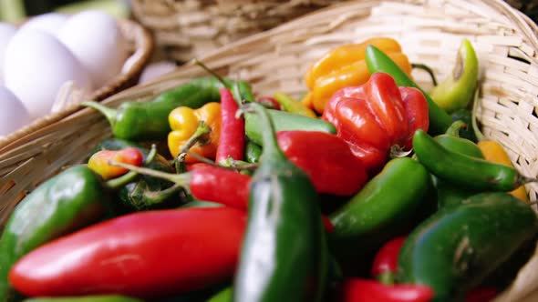 Capsicum vegetables and eggs in a wicker basket