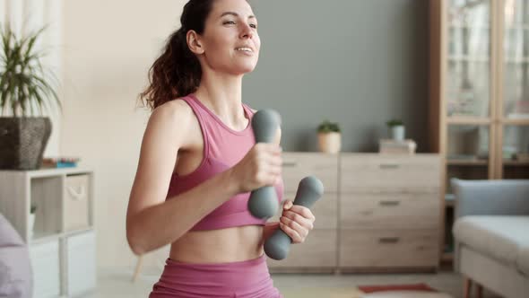 Happy Woman Doing Punches with Dumbbells