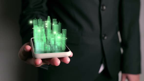 Businessman holds 3D city model showing augmented reality technology