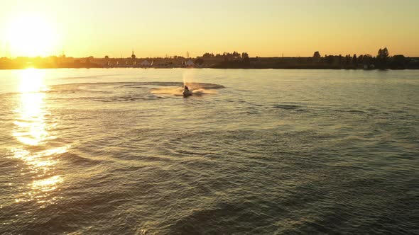 People on a Water Scooter are Making Turns on the Water