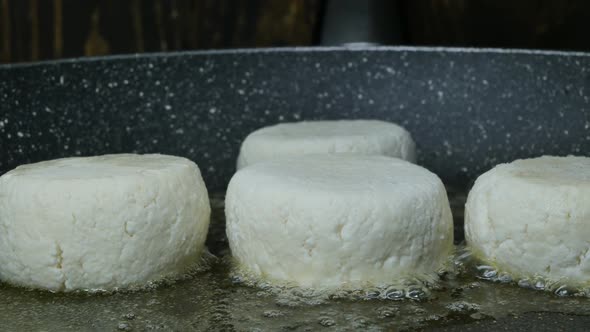 Fry Cottage Cheese Pancakes in a Frying Pan on Both Sides in Melted Butter