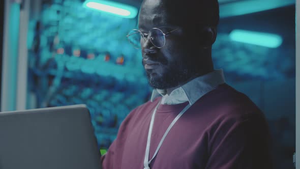 African American IT Professional Working in Server Room