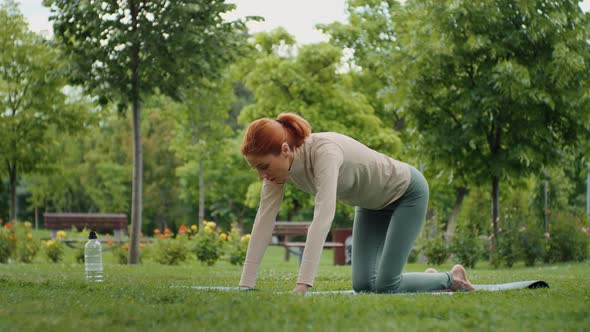 Woman stretching back muscles, outdoor.