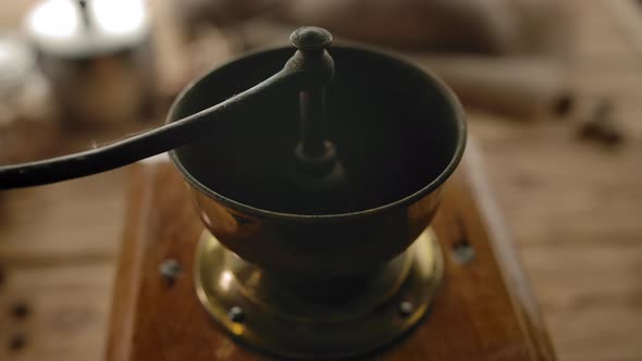 Dropping Roasted Coffee Beans Inside of Coffee Grinder