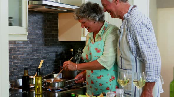 Senior couple cooking food in kitchen 4k