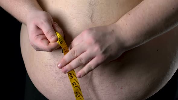 Fat Man Measuring His Belly With Yellow Tape, Weight Loss Control, Diet Result