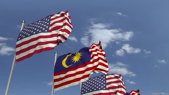 Flags of Malaysia and the USA Against Blue Sky