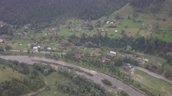 Aerial summer view to Carpathian village Kryvorivnia amidst mountains