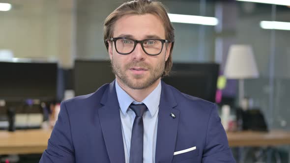 Portrait of Businessman Looking at Camera