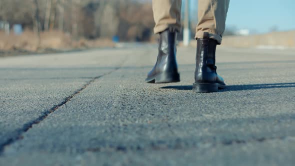 Man Legs Walking.Man On Sneakers Legs Walking.Leather Shoes. Man Feet Walking On Road.Park