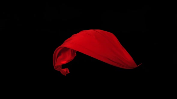 Red fabric flowing on black background, Slow Motion