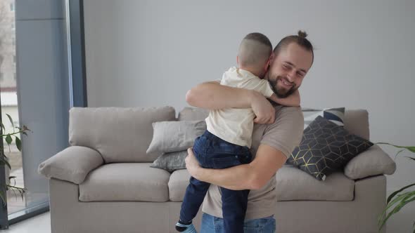 father hugging with little son