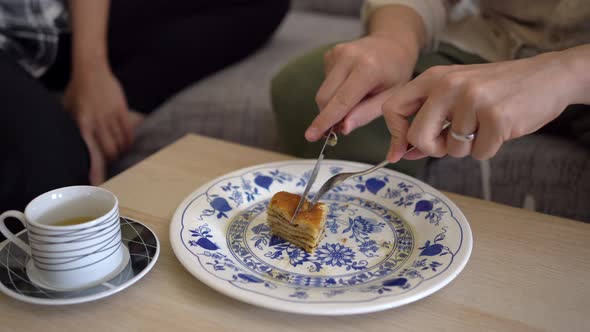 Anonymous couple eating tasty pancakes