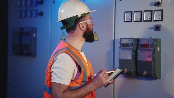 Electrical Expert Taking the Readings of Meter at the Plant