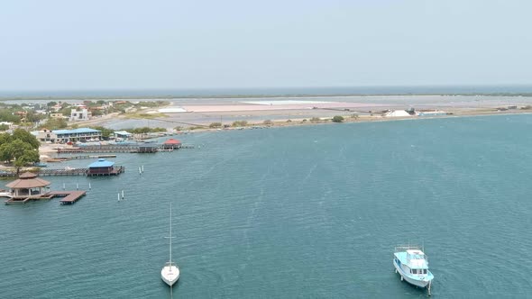 Las Calderas bay with salt pants in background, Dominican Republic. Aerial forward