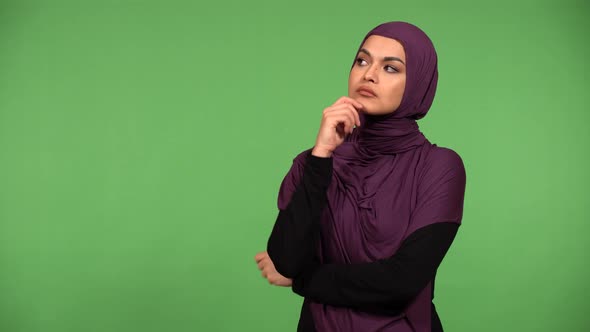 A Young Beautiful Muslim Woman Thinks About Something  Green Screen Background