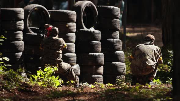 Paintball Sport Player Wearing Protective Mask Aiming Gun Shelter Attack