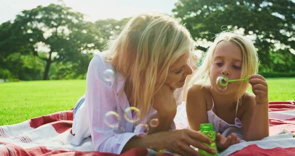 Mother and Daughter Relaxing in Park