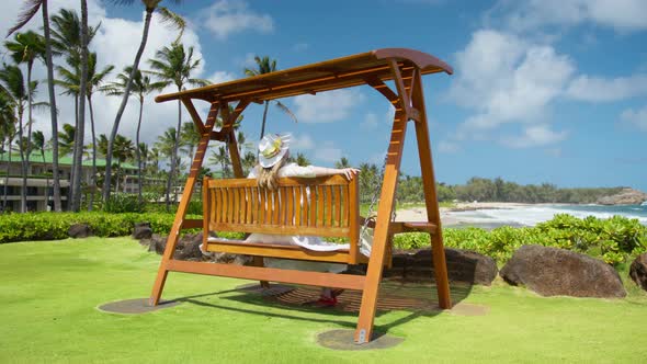 Happy Summer Vacation Dream Concept Woman Swinging on Wooden Swing at Beach