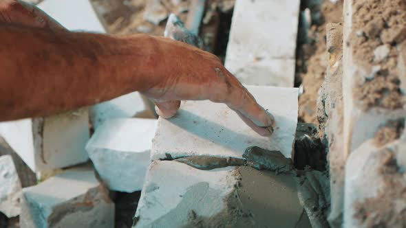 Construction Worker or Mason Laying Bricks and Creating Walls. Bricklayer Laying Bricks To Make a