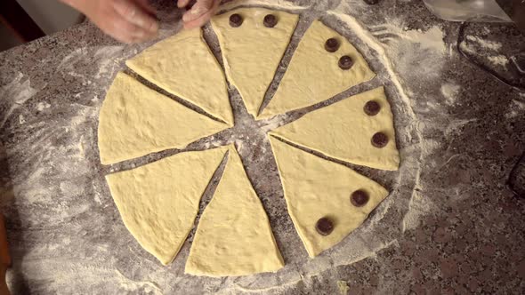 woman twisting pieces and prepare croissant