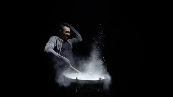 Portrait of a Drummer in Profile on a Black Background