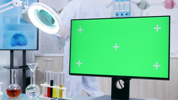 Static Shot of Chemist Desk with a Green Screen Mock-up Desktop PC