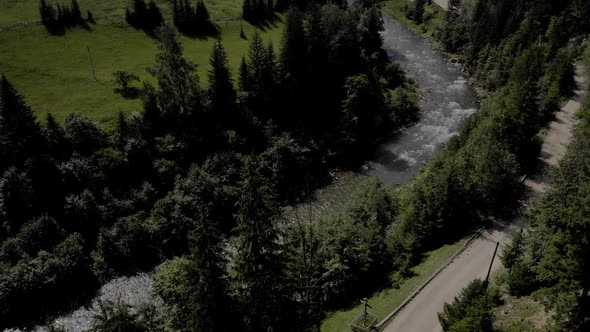 Top View of River Flowing Near Road in Mountains