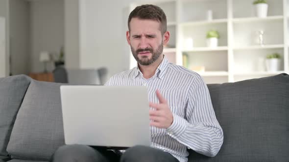 Shocked Young Man Reacting to Failure at Home