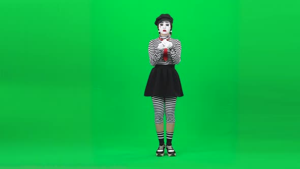 Mime Girl Is Putting on Lipstick. Chroma Key. Full Length.