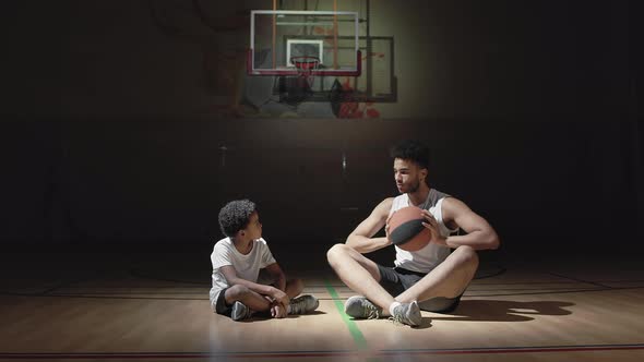 Basketball Player Teaching Boy